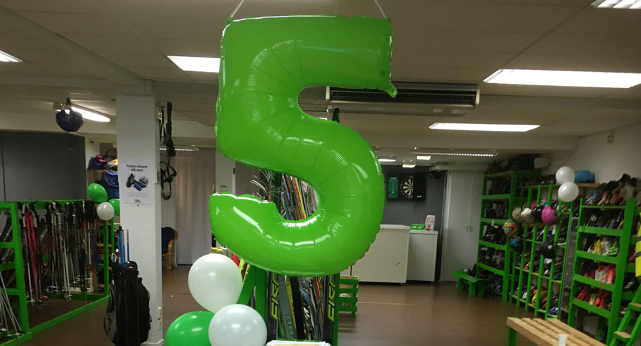 Inne i fritidsbanken med stor grön ballong i formen av en femma.